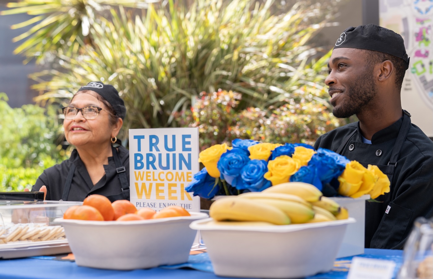 Move-in: Two UCLA Dining staff at table with food