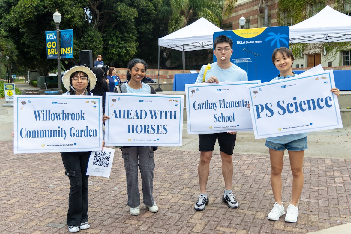 Volunteer-Students holding signs for volunteer locations
