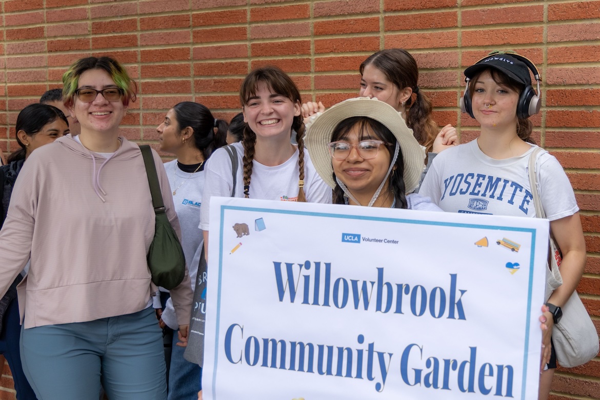 Volunteer-Students with Willowbrook Community Garden sign