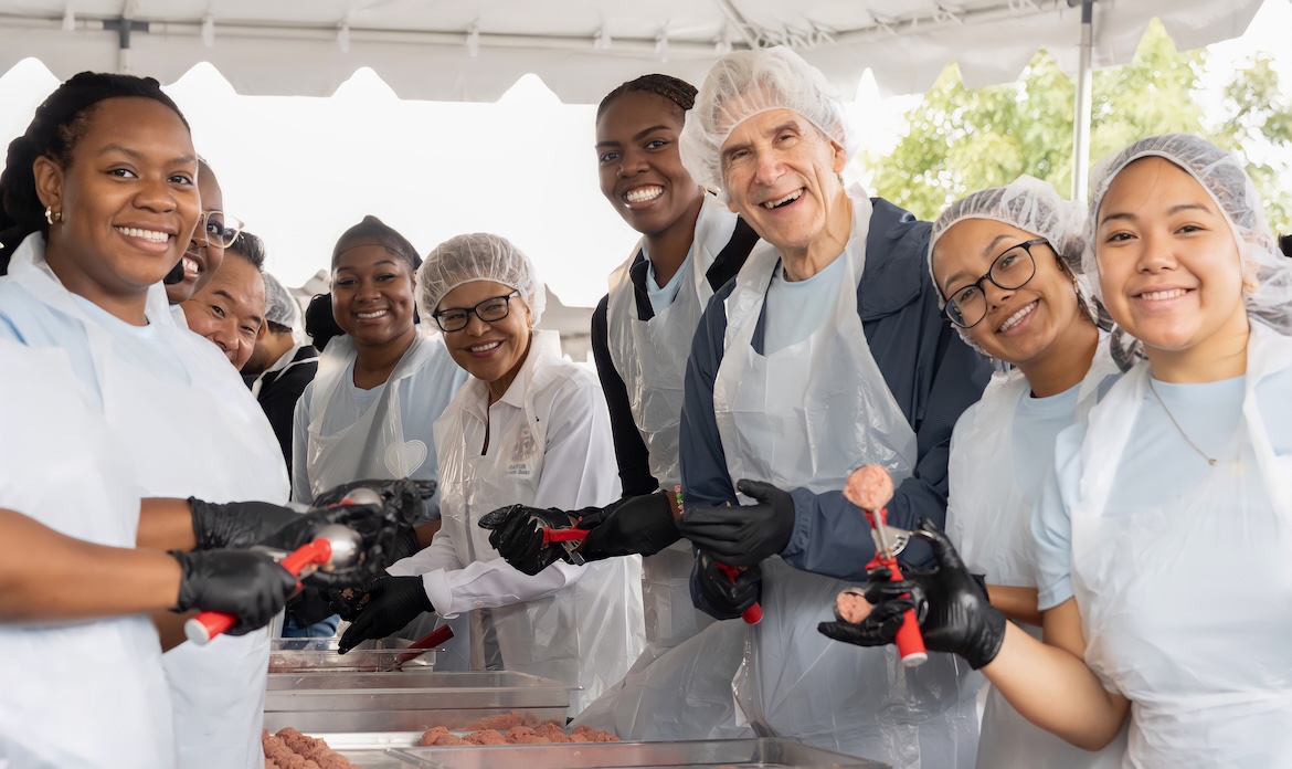 Chancellor Frenk, Mayor Bass and students making meatballs