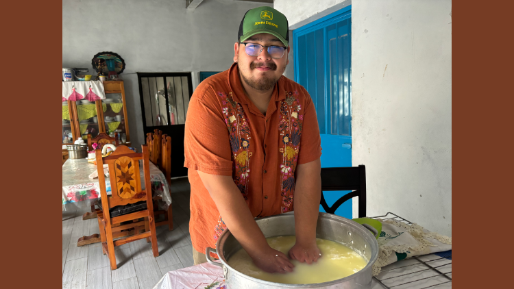UCLA student Guillermo Miranda making cheese by hand