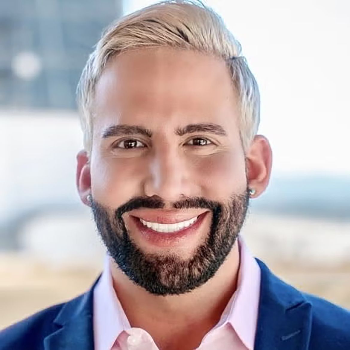 Close-up of Matthew Mimiaga, in blue jacket and pink button-down shirt