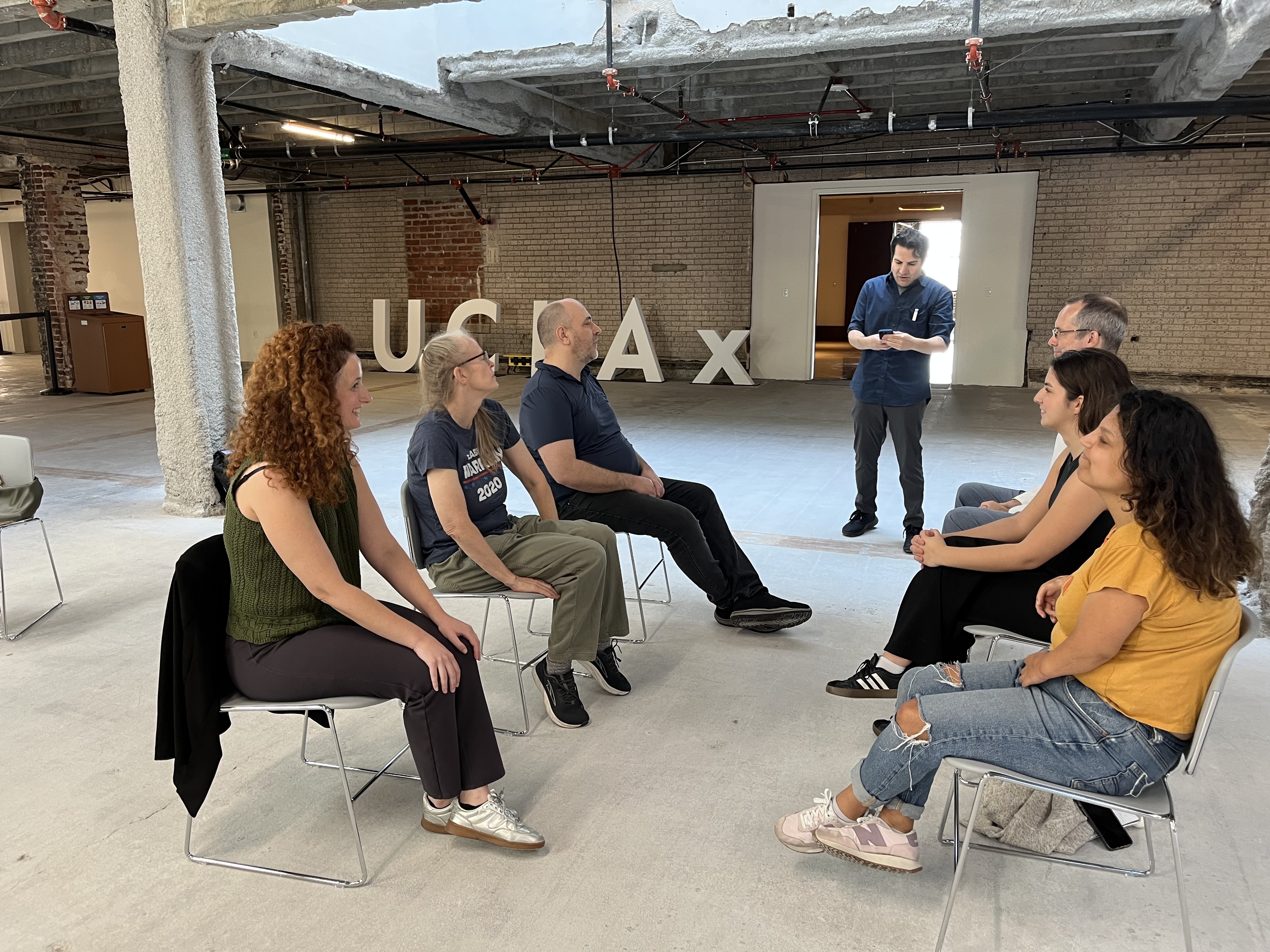 Actors in UCLA Extension workshop at UCLA Downtown face each other in chairs as instructor speaks