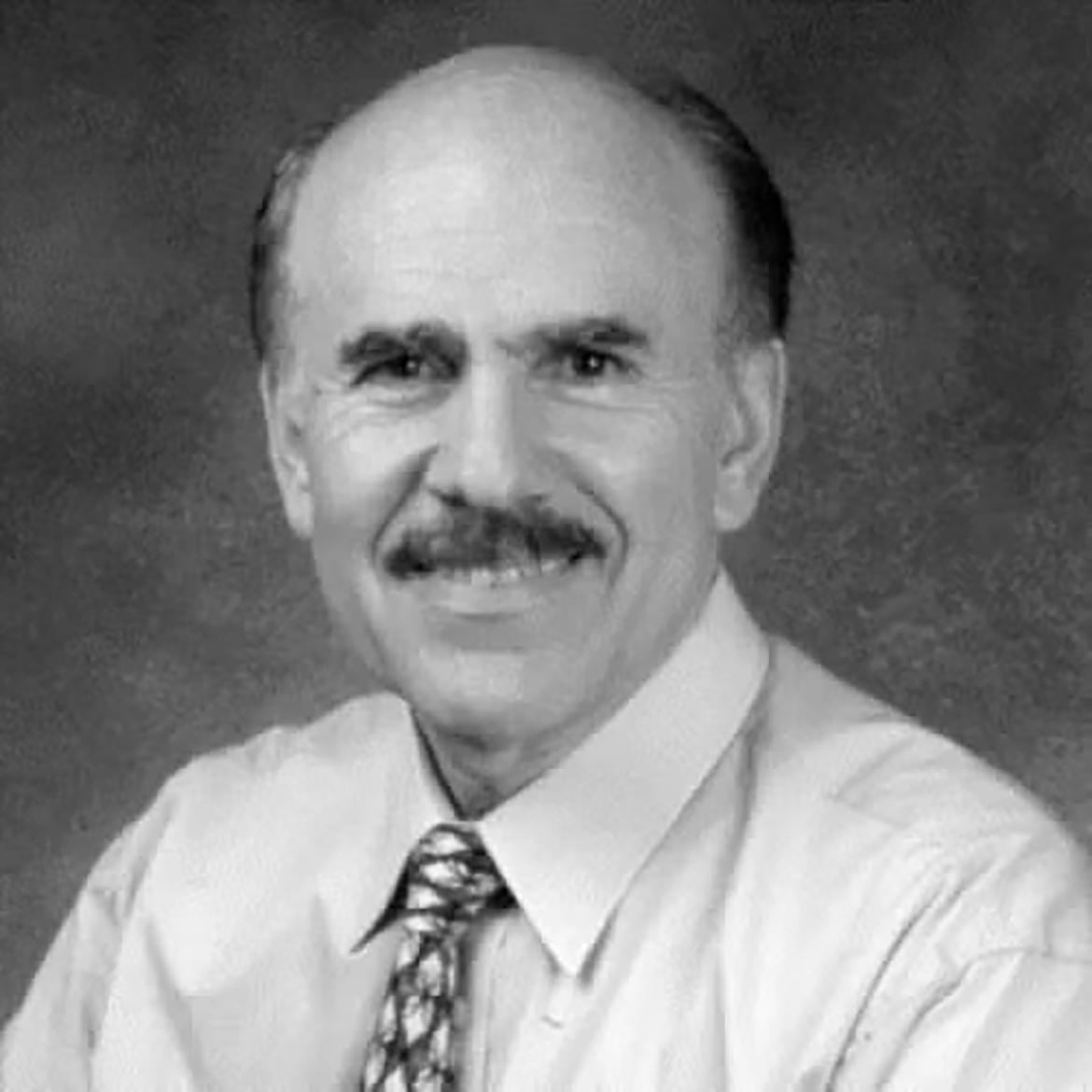 Black-and-white portrait of Louis Ignarro with tie and moustache