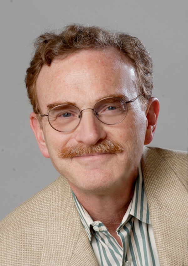 Randy Schekman head-and-shoulders portrait in striped green-and-white shirt and tan jacket