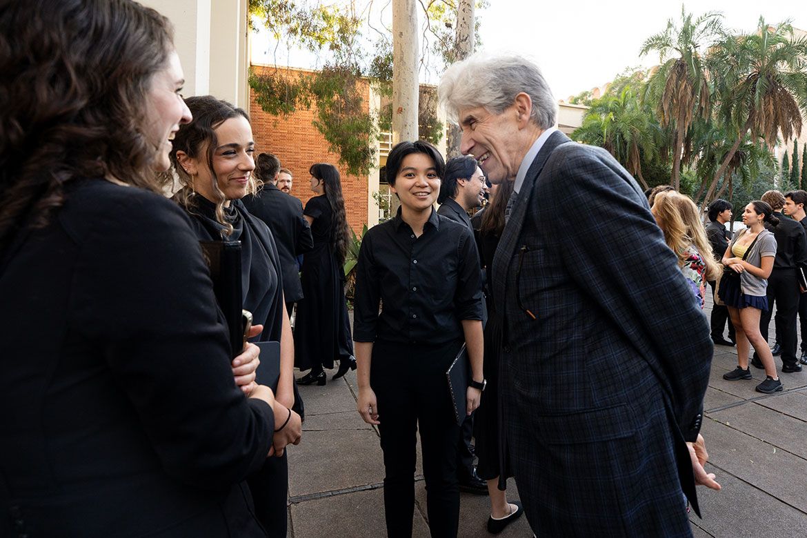 Chancellor Frenk speaks with student performers following the ceremony. 