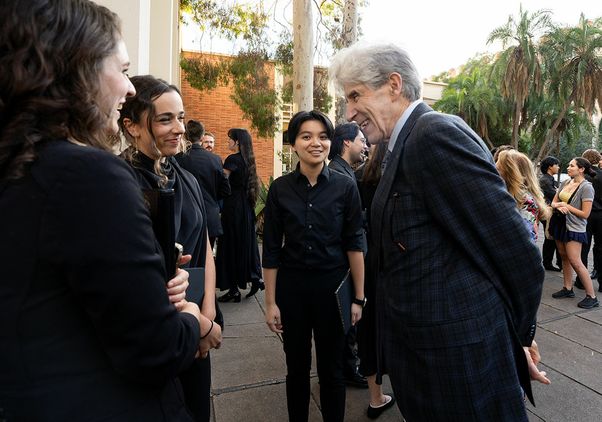 Chancellor Frenk speaks with student performers following the ceremony. 