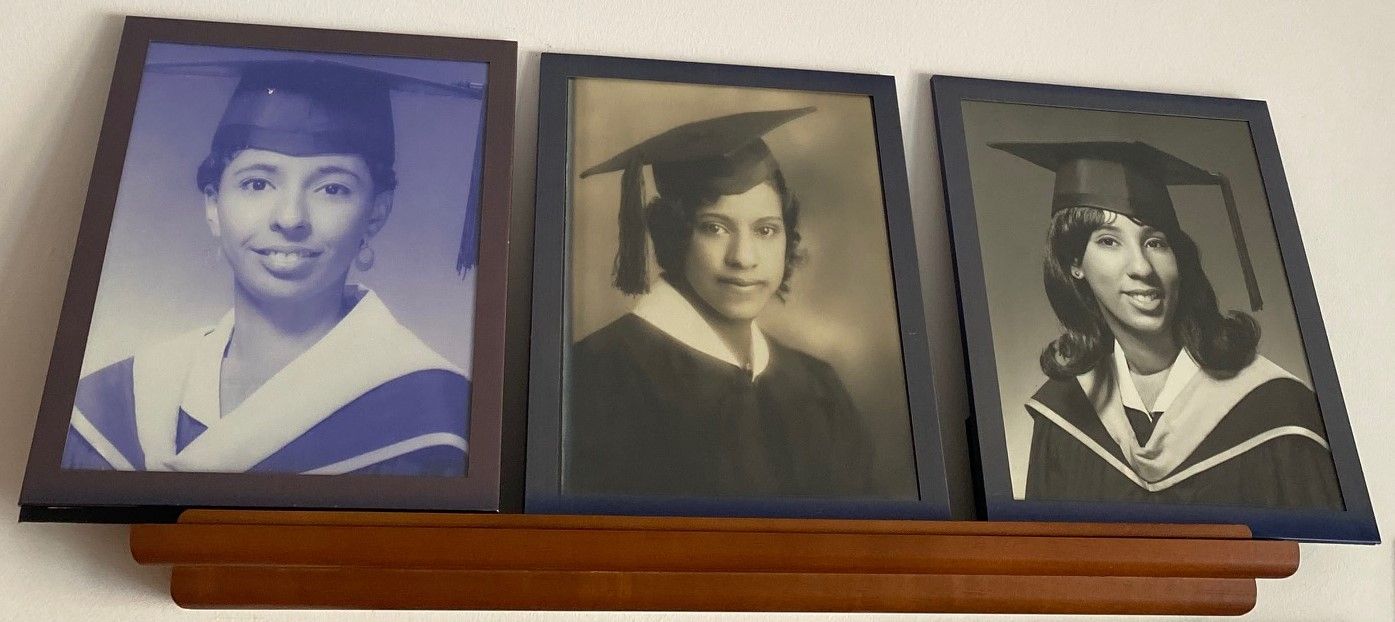 Three framed graduation portraits on a wooden shelf, from left: Teresa White Riddle, Edith Keyser White, and Alice White Parrish.