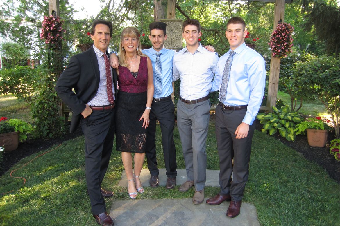 The Nelson family poses together in a garden, from left: Allen, Rose, Brandon, Trent, and Justin.