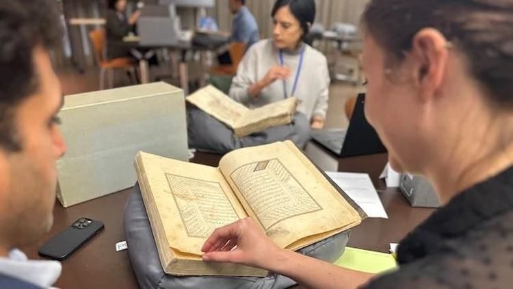 Researchers and scholars examine rare Arabic-script manuscripts from UCLA's collection during a hands-on session.