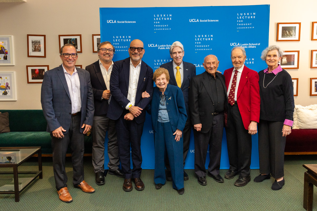From left to right, Michael Waterstone, Miguel García-Garibay, Abel Valenzuela, Renee Luskin, Julio Frenk, Meyer Luskin, Jared Diamond and Marie Cohen stand in front of a blue step-and-repeat banner