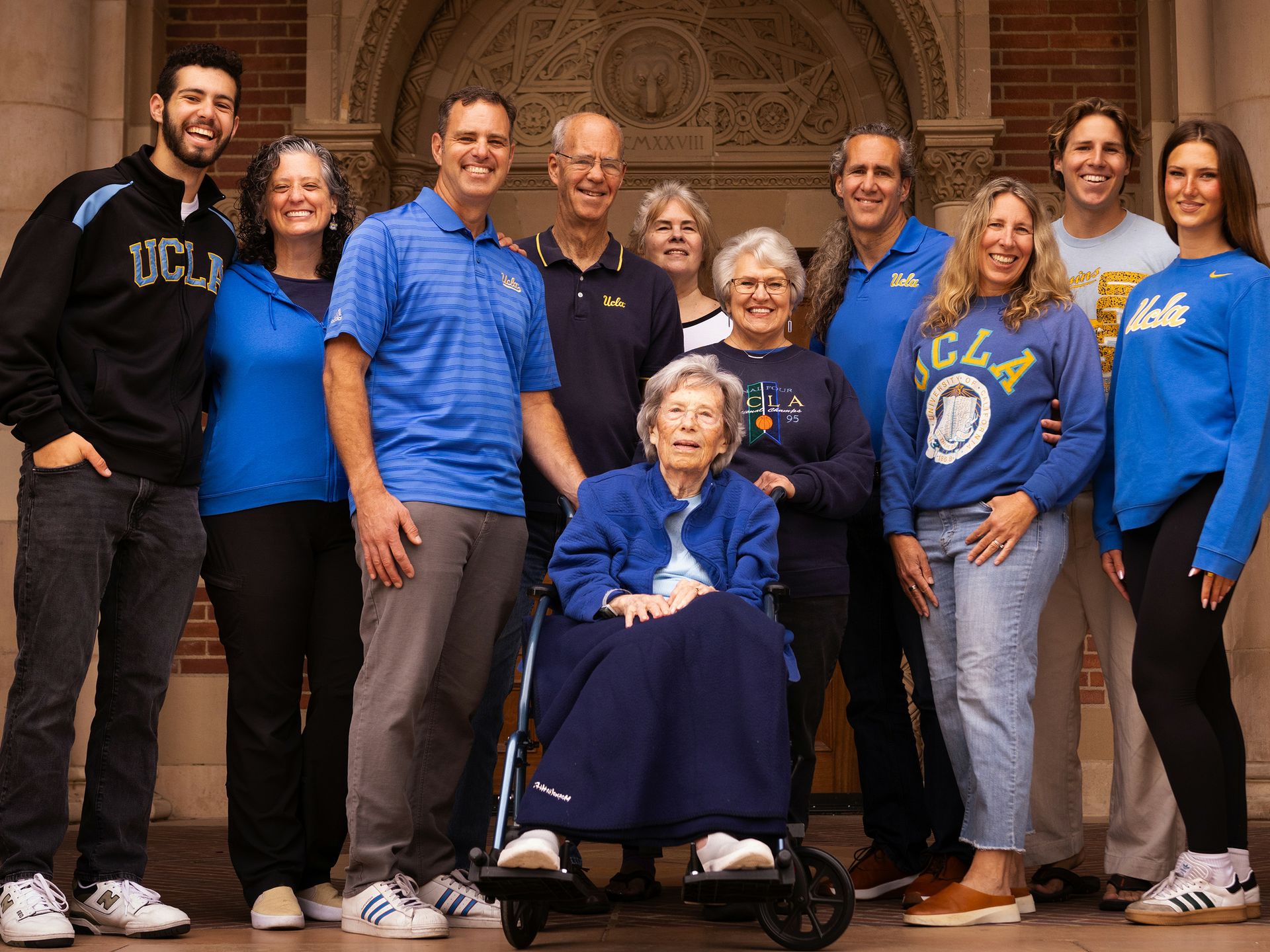 An extraordinary portrait on the UCLA campus of 11 members of the Wallis family, representing UCLA alumni from across four generations: Marilyn Heinmiller, the matriarch, sits in a wheelchair in front.