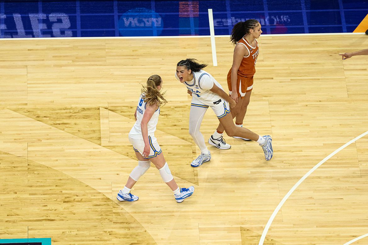 UCLA's Gianna Kneepkens and Lauren Betts celebrate on the court during their Final Four matchup against Texas.