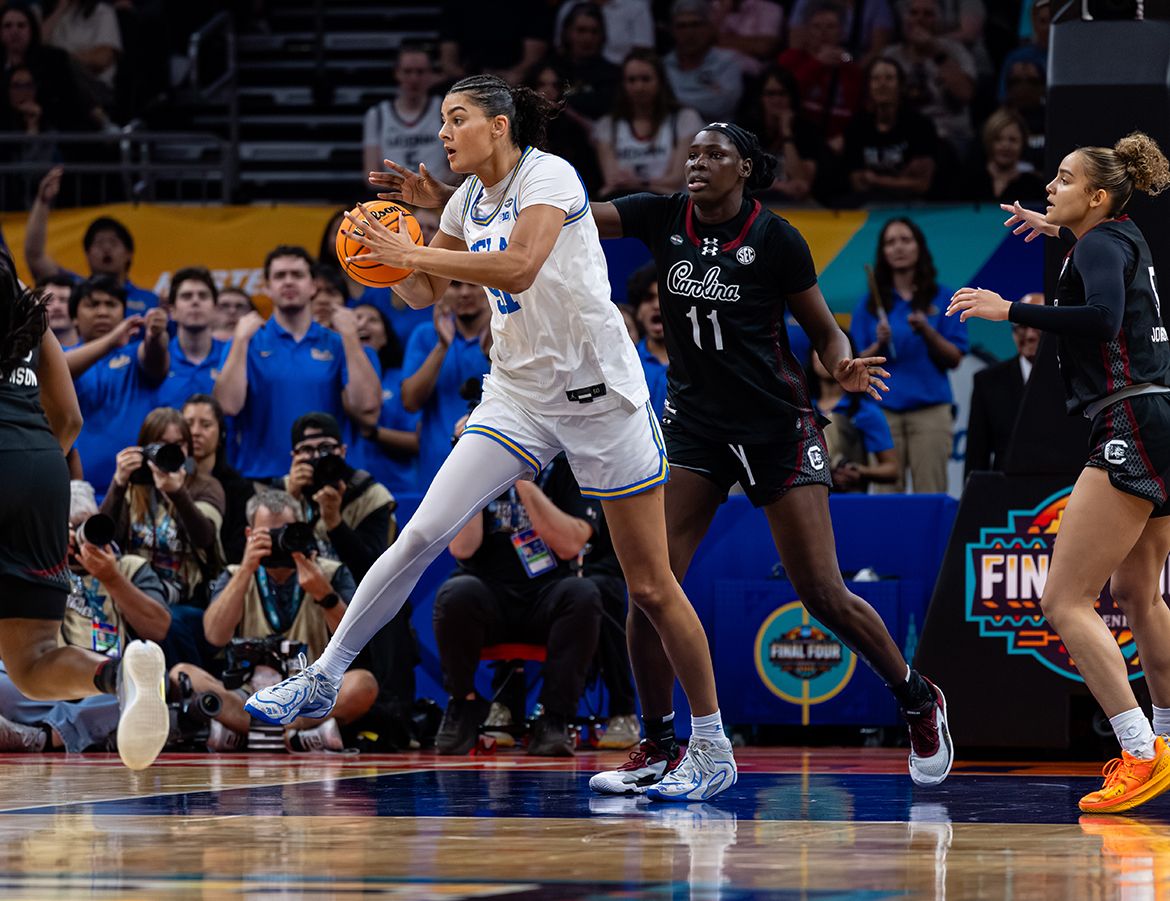 UCLA center Lauren Betts drives with the ball against South Carolina defenders during the NCAA Final Four championship game.