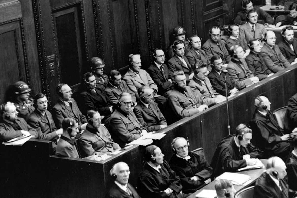 Black-and-white photo of approximately 20 defendants in the Nazi doctors trial, held in Nuremberg, Germany, from Dec. 9, 1946–Aug. 20, 1947.  