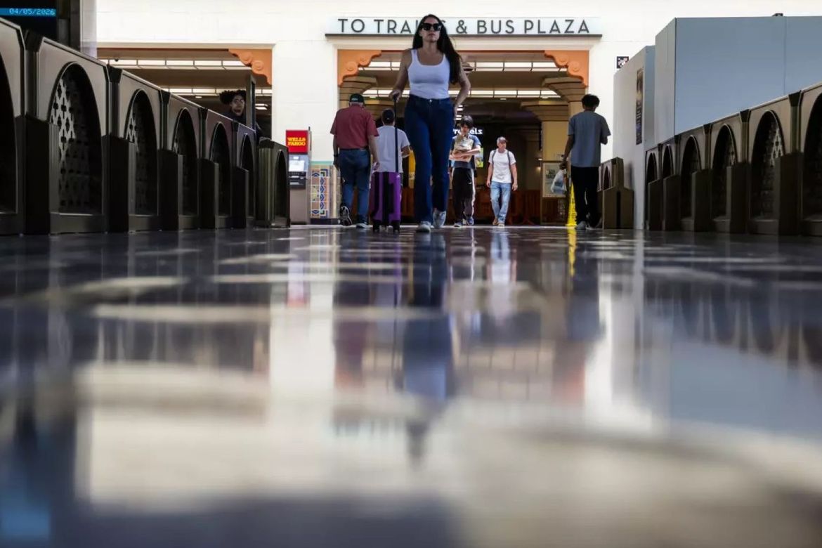 Ground-level shot of woman in white tank top walking through Union Station hallway