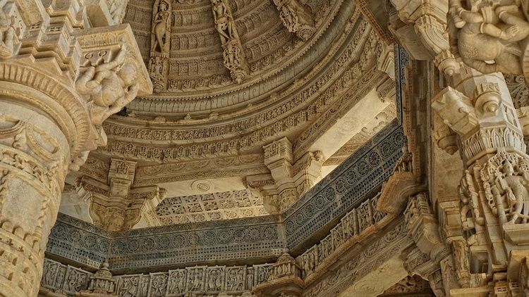 Intricate stone carvings cover the interior ceiling, columns and arches of the Ranakpur Jain temple in Rajasthan, India.