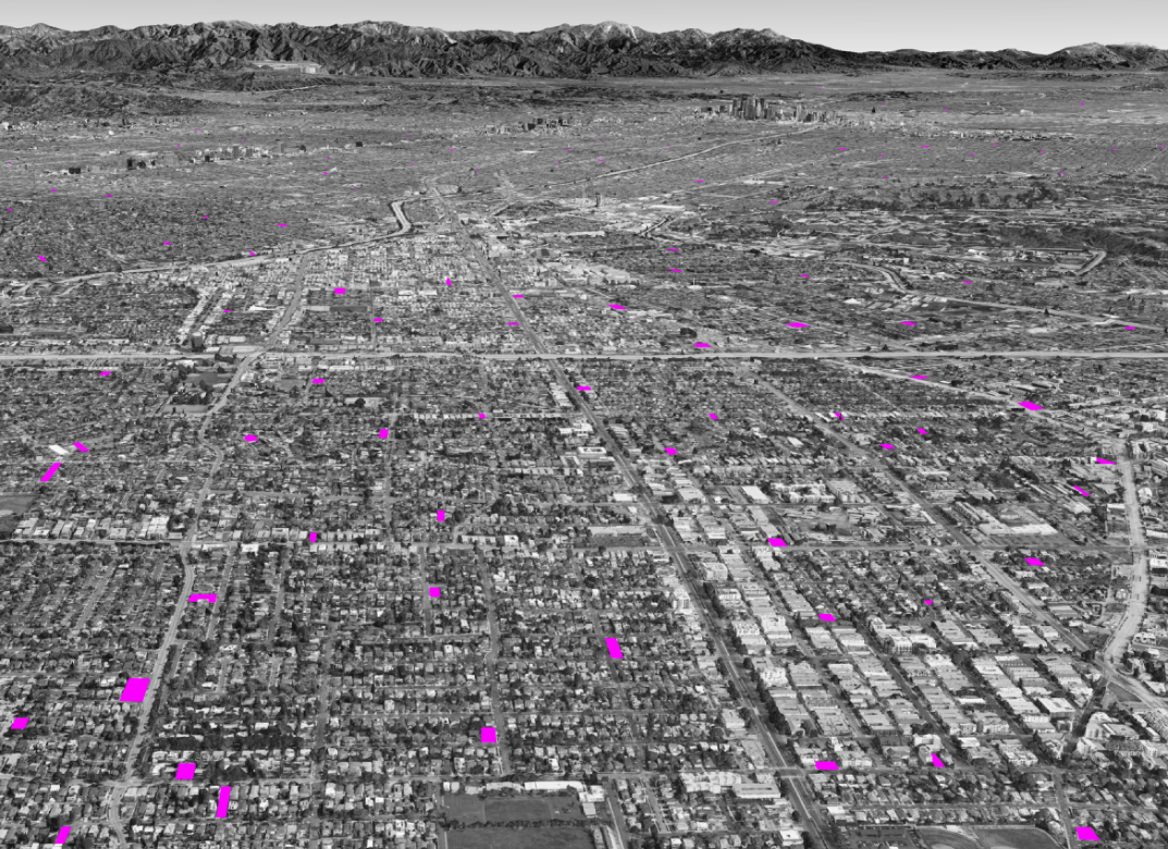 Grayscale aerial view of the LA basin with potential land parcels for development identified in pink