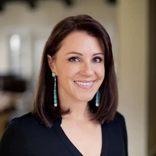 Close-up of Angela Riley, with long dark hair and turquoise earrings