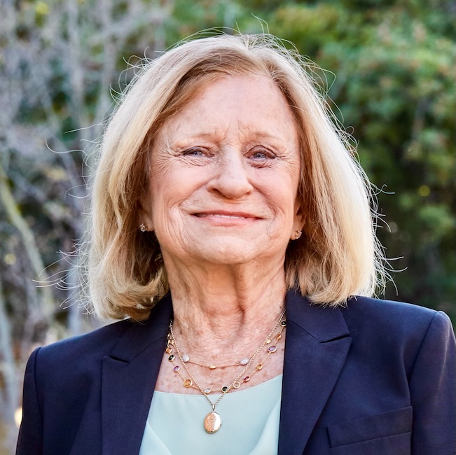 Close-up of Eva Baker, with blonde shoulder-length hair and a navy blazer