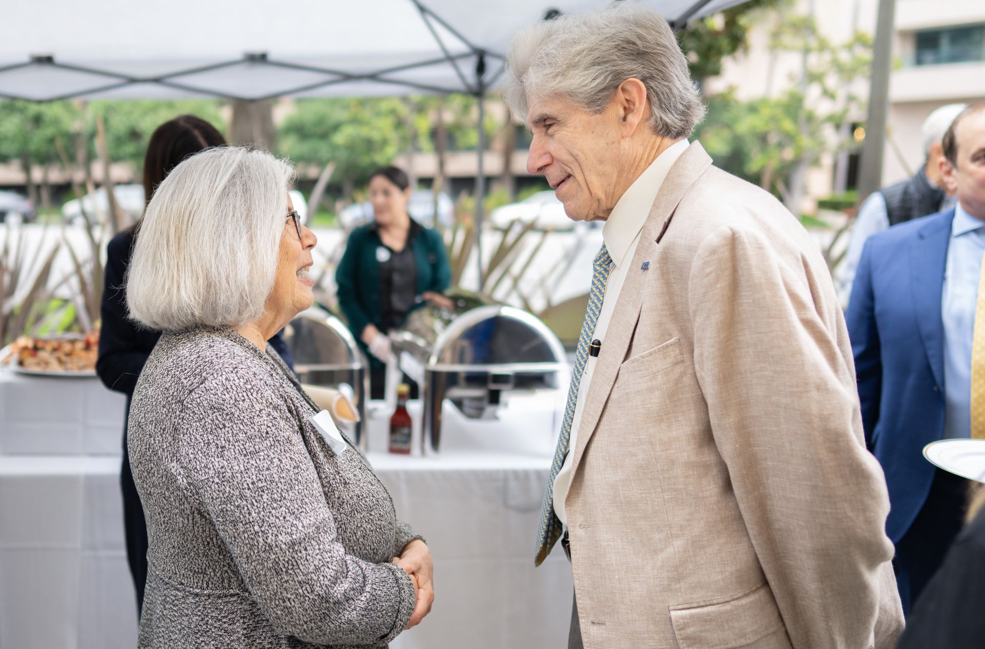 UCLA Chancellor Julio Frenk speaks with a community member during an outdoor gathering with Westwood and neighboring Los Angeles residents.