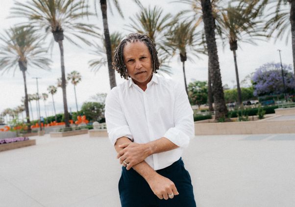 Cobi Jones in a white button-up shirt and slacks standing on the grounds of Dignity Health Sports Park