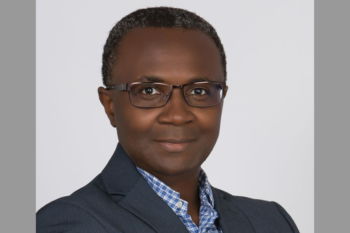 Headshot of Onyebuchi Arah in blue-and-white checkered print button-down and gray jacket
