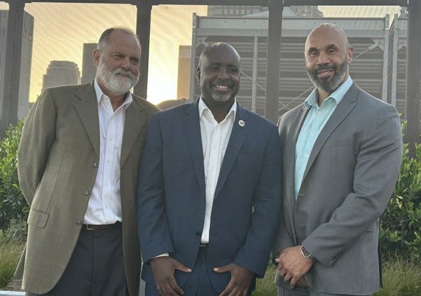 From left, Jim Newton, Los Angeles City Council President Marqueece Harris-Dawson and UCLA Executive Vice Chancellor and Provost Darnell Hunt pose together on the rooftop of UCLA Downtown.
