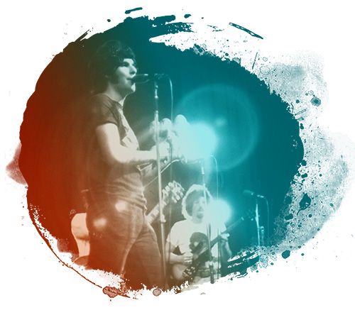 Harold Bronson singing into a microphone onstage, with a guitarist blurred in the background. The image is framed by a circular paint-splatter graphic and overlaid with teal and orange light effects.