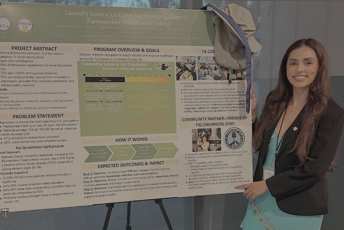 Denise Jimenez-Tapia stands in front of her poster about bridging gaps in farmworker health and safety