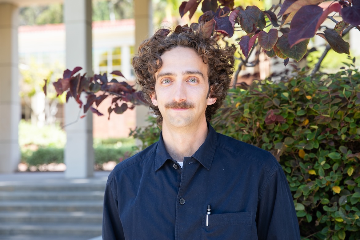 Head-and-shoulders shot of Hunter Blackwell in black shirt outside on UCLA campus
