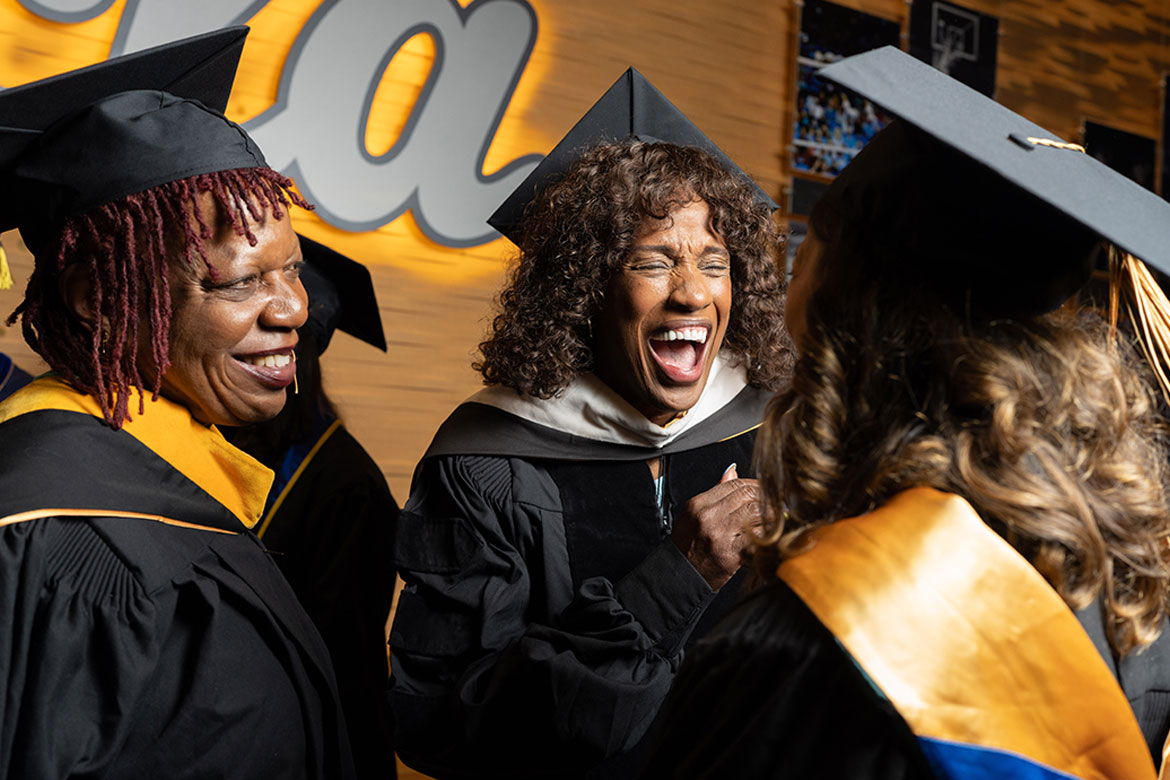 Jackie Joyner-Kersee laughs with faculty members at UCLA's 2026 commencement.