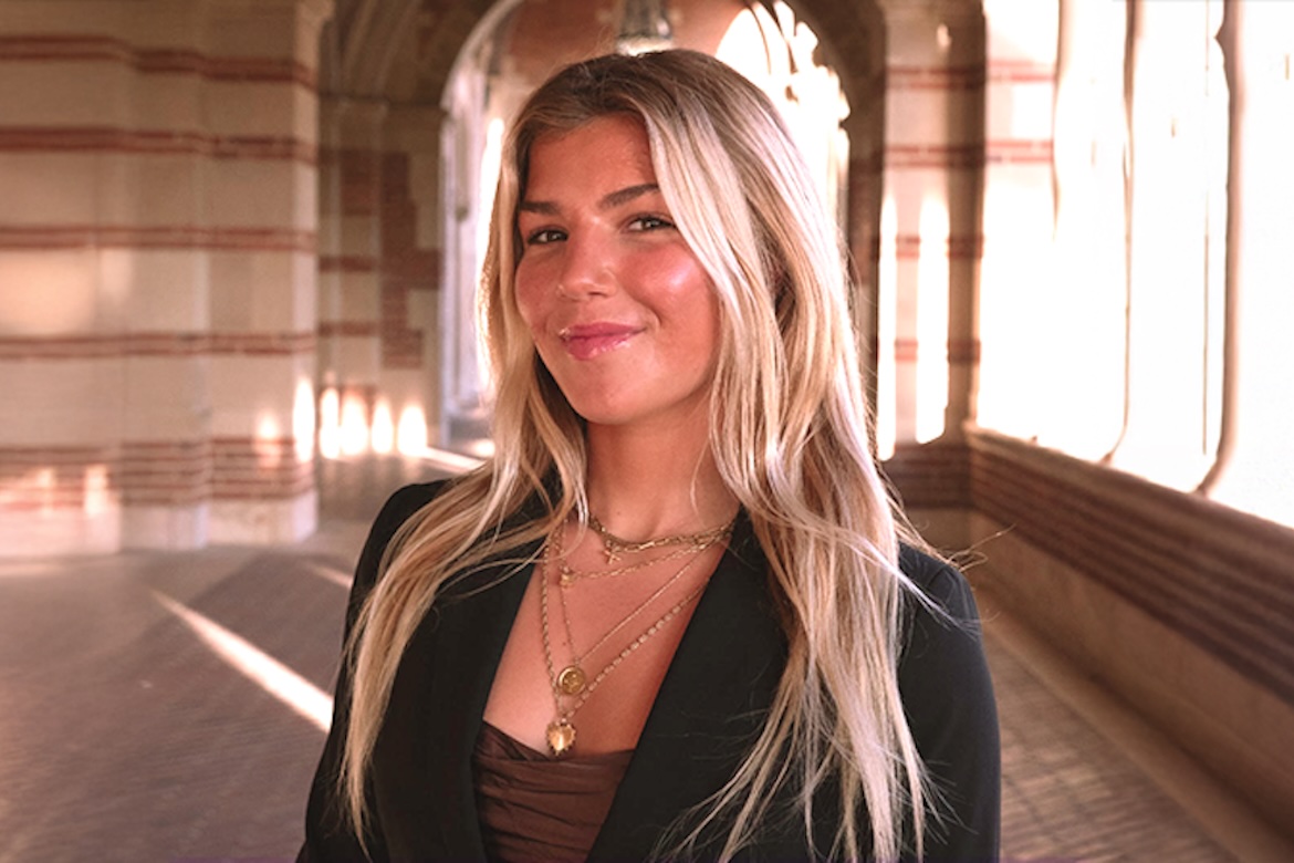 Head-and-shoulders shot of Lilie Kulber smiling while standing in Royce Hall portico.