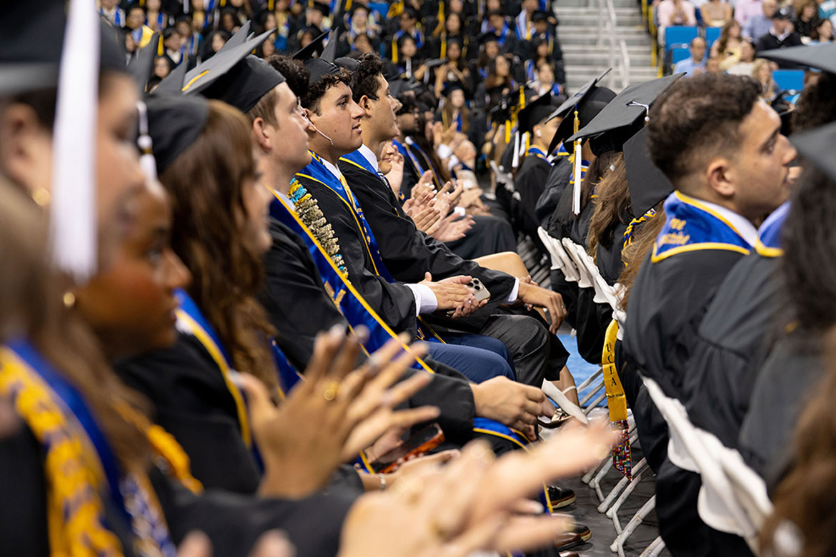 Graduates applaud while seated at UCLA's 2026 commencement.