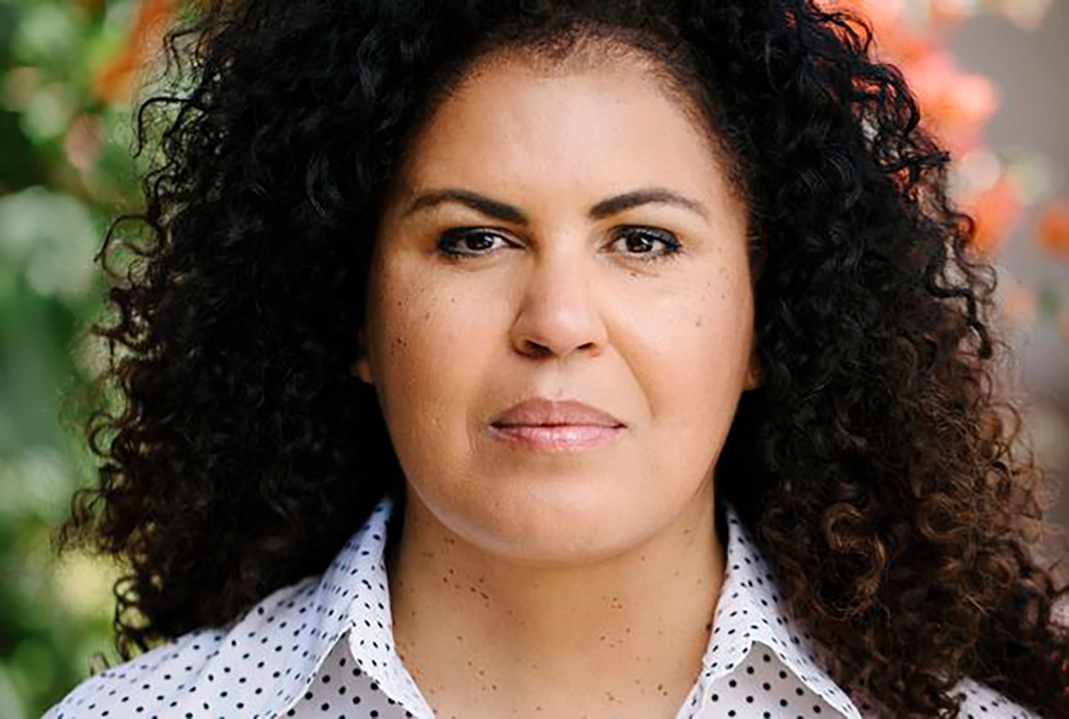 Close-up of Safiya Noble in a white and dark blue polka dot top