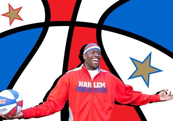Kevin Daley in Harlem Globetrotter warmups, smiling holding a Globetrotters basketball