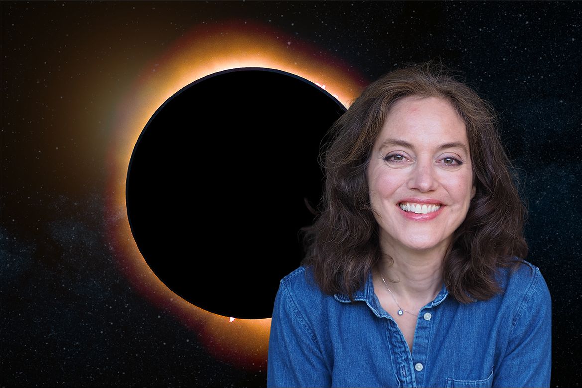 Amy Mainzer, in a blue denim shirt, posed in front of a dramatic solar eclipse against a star-filled space background.