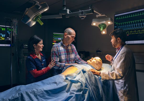 Yvonne Caro Caro performs a simulation with a mannequin and two other actors 