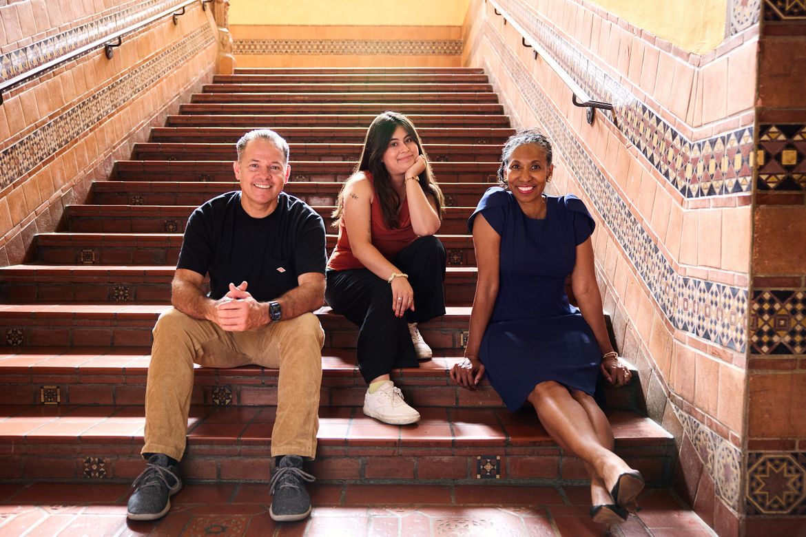 Benjamin Lewis, Daniela Cortez Bravo and Angela Deaver Campbell sitting together on the steps 
