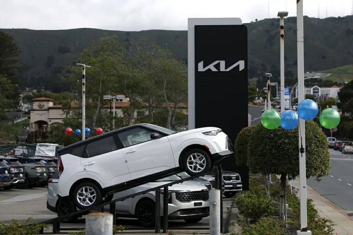 Brand-new Kia vehicles displayed at a dealership in Colma, California.