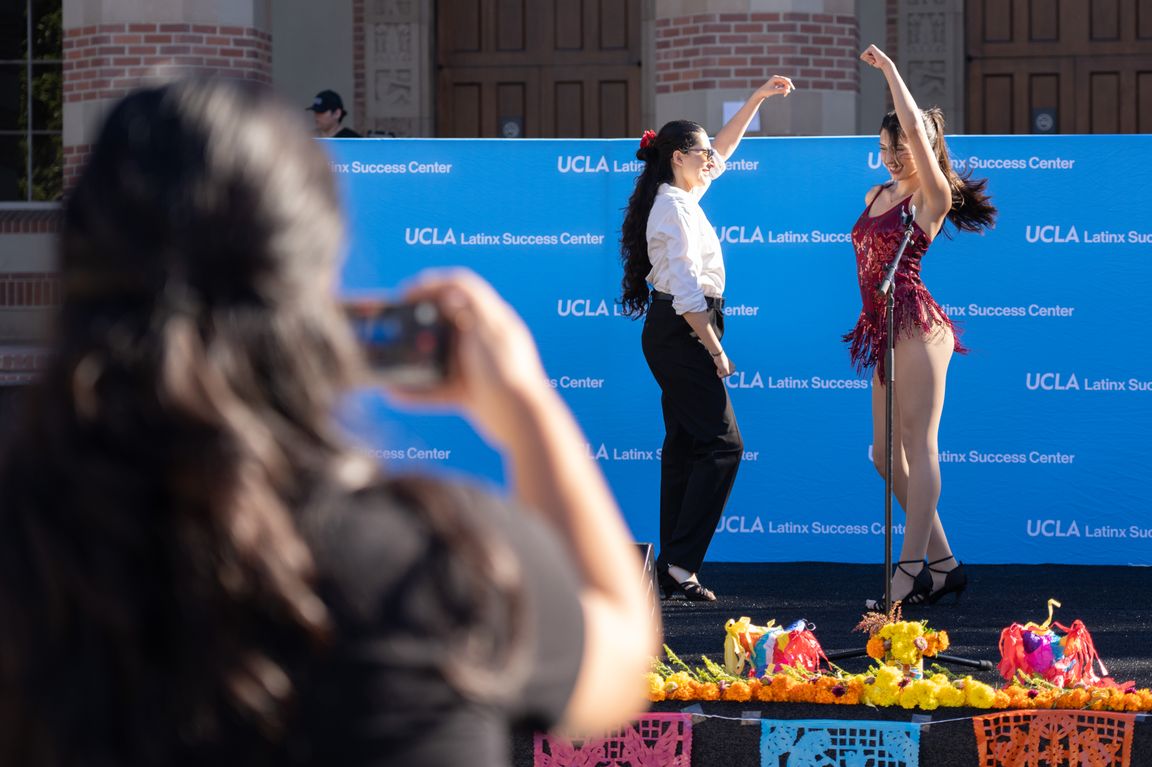 Sashi Atkinson Osorio (right) and a fellow member of UCLA’s Ritmo Vivo Latin dance team perform together at the 2026 Latinx Welcome celebration.