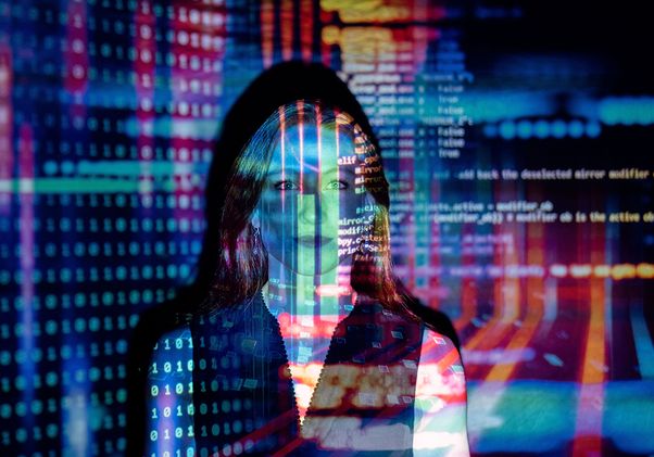 A woman with digital code projections on her face, representing technology and future concepts.