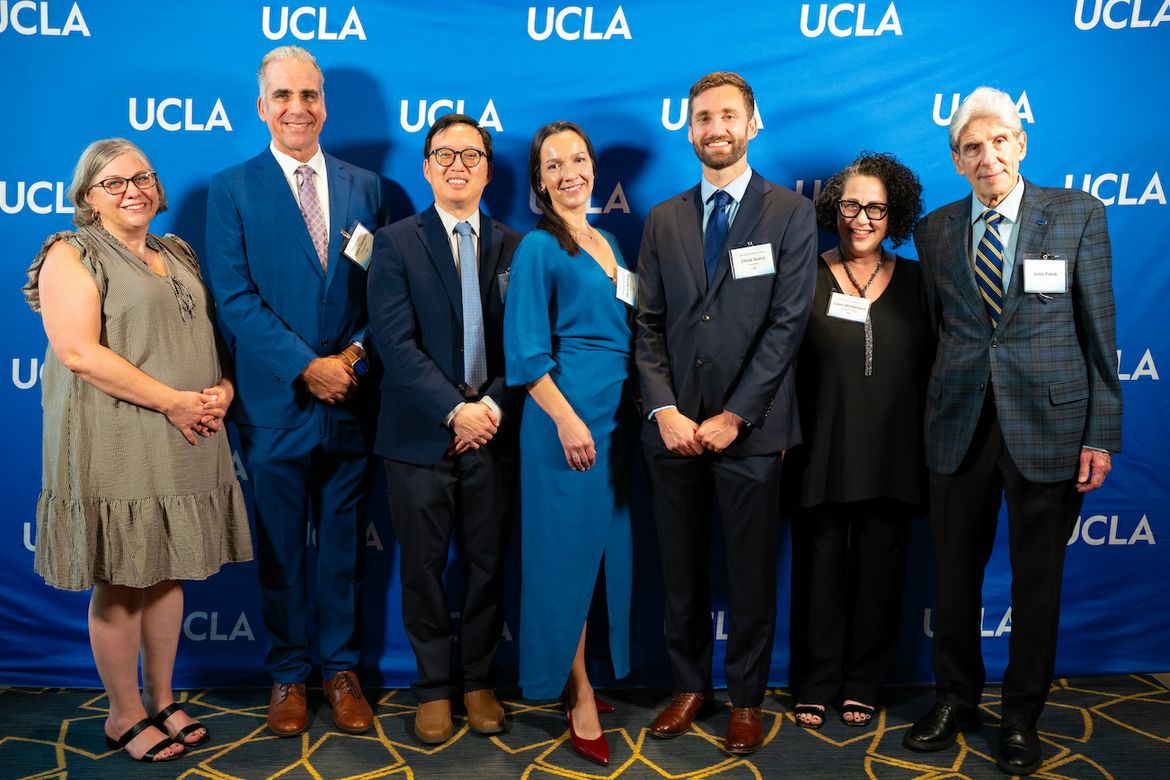 Seven people, including UCLA Chancellor Julio Frenk (far right), stand together and smile for a group photo in front of a blue UCLA backdrop at the 2026 Andrea L. Rich Night to Honor Teaching