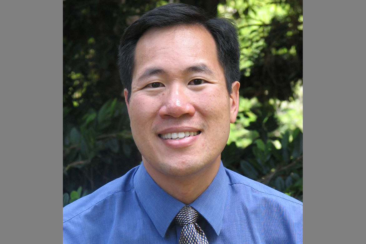 Head-and-shoulders photo of Michael Ong wearing a blue button-down and tie.