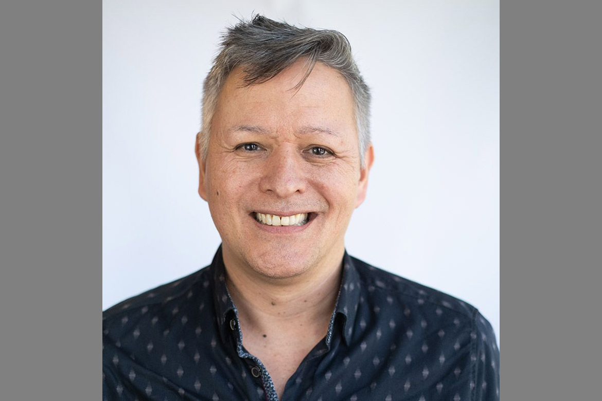 Head-and-shoulders portrait of Sean Metzger wearing a patterned dark blue shirt.
