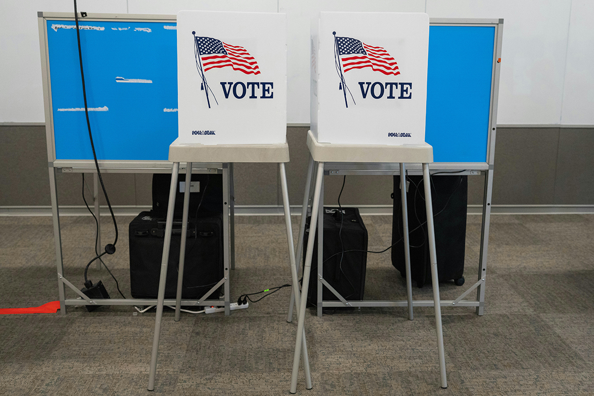 Two voting booths with blue privacy panels and