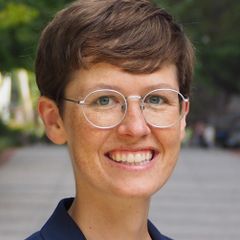 Headshot of Karen McKinnon wearing glasses, photographed outdoors.
