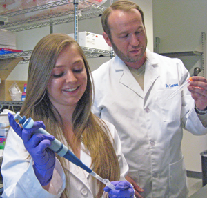 UNM student Katharine Epler and Chemical and Nuclear Engineering Research Assistant Professor Eric Carnes in the lab.