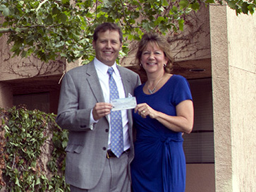 The family of Micheal W. Hansen presents check to the UNM Center for Surgical Critical Care.