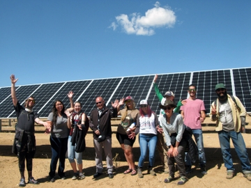 UNM-T Natural Resources Management students and Luis Reyes, CEO of Kit Carson Electric Cooperative, show their enthusiasm for solar panels that turn sunshine into electricity L Reyes _ Students at Array